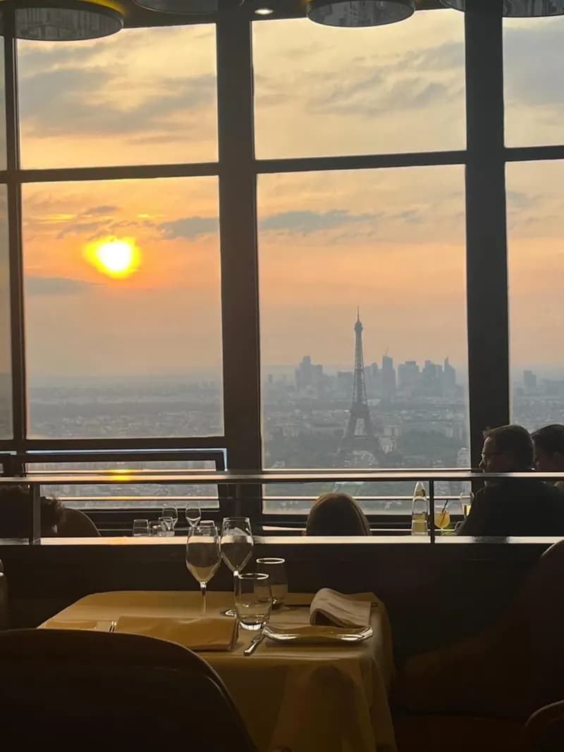 Ciel de Paris dining room at sunset, overlooking the Eiffel Tower and La Défense